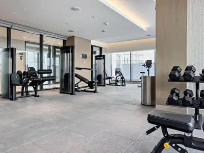 a gym with treadmills and exercise equipment in a building at Elegant 1BR Sobha Crest City Views in Dubai