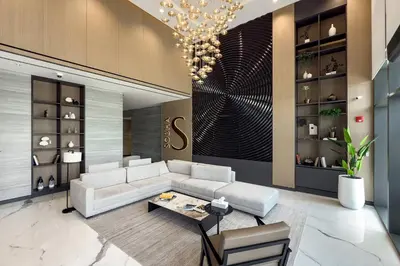 a living room with a white couch and a chandelier at Chic 1BR Retreat Sobha Crest with Pool & Gym in Dubai