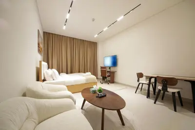 a living room with a couch and a table at Wecation - Cozy Studio , Trillionaire , Private Jacuzzi in Dubai