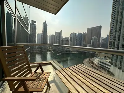 a balcony with a bench and a view of a city at sanibel tower in Dubai
