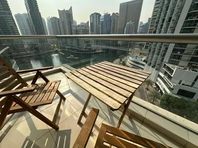 a table and two chairs on a balcony with a city at sanibel tower in Dubai