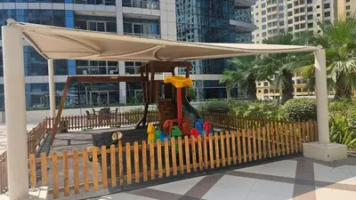 a park with a playground with a canopy at Bay Central 1BR with Full Marina View in Dubai
