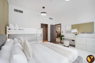 a white bedroom with a large white bed and a bathroom at Vogue Business Bay Royal Regency near Downtown, Burj Khalifa and Dubai Mall, One Bedroom Apartment with Balcony and partial Burj Khalifa view, Access to all Amenities in Dubai