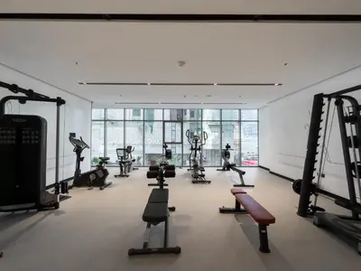a gym with many exercise equipment in a room at Vogue Business Bay Royal Regency near Downtown, Burj Khalifa and Dubai Mall, One Bedroom Apartment with Balcony and partial Burj Khalifa view, Access to all Amenities in Dubai