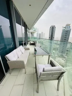 a balcony with a table and chairs on a building at Amazing apartment on Stella Maris 2BR in Dubai