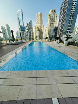 a large swimming pool in a city with tall buildings at Amazing apartment on Stella Maris 2BR in Dubai