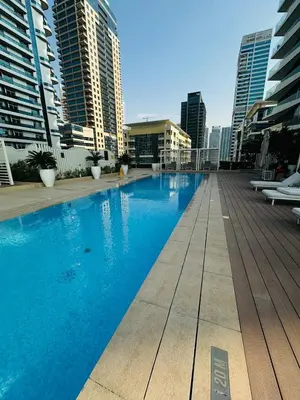 a swimming pool on the roof of a building with tall buildings at Amazing apartment on Stella Maris 2BR in Dubai