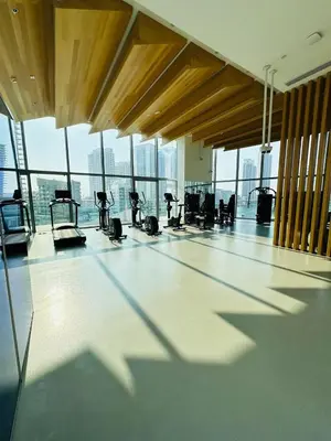a gym with cardio equipment in a building with windows at Amazing apartment on Stella Maris 2BR in Dubai