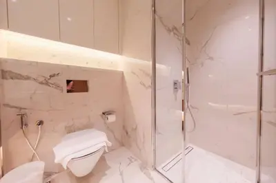 a bathroom with a glass shower and a toilet at Modern Studio Azizi Riviera 59 Al Merkadh Community in Dubai