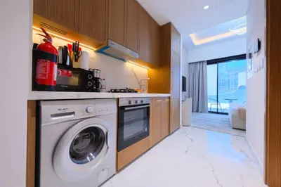 a laundry room with a washer and dryer at Modern Studio Azizi Riviera 59 Al Merkadh Community in Dubai