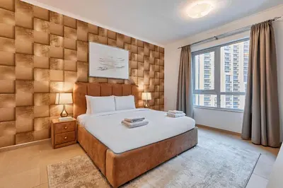a bedroom with a large bed and a large window at Downtown View 2BHK in Dubai