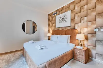 a bedroom with a large bed and a mirror at Downtown View 2BHK in Dubai
