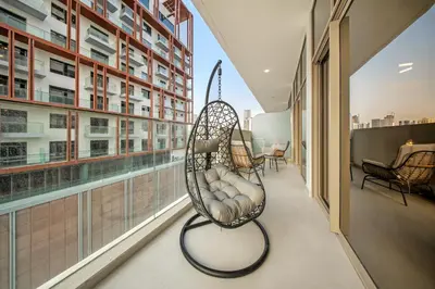 a hanging chair in a room with a window at Spacious 1BR in JVC with Pool and Gym Access in Dubai