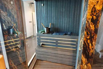 a bathroom with a shower with two potted plants at Iconic Triplex Penthouse in Marina in Dubai
