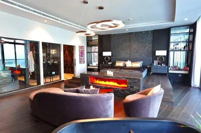 a living room with a couch and a fireplace at Iconic Triplex Penthouse in Marina in Dubai
