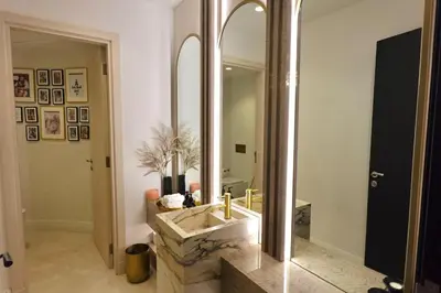 a bathroom with a sink and a large mirror at Iconic Triplex Penthouse in Marina in Dubai