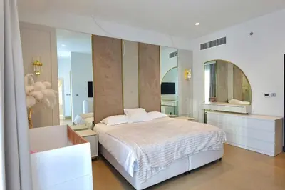 a bedroom with a large bed and a large mirror at Iconic Triplex Penthouse in Marina in Dubai