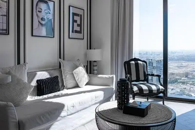 a living room with a white couch and a chair at The Address JBR, Address Beach Resort, Marina View - Onelink in Dubai