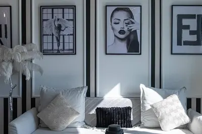 a living room with a couch and pictures on the wall at The Address JBR, Address Beach Resort, Marina View - Onelink in Dubai