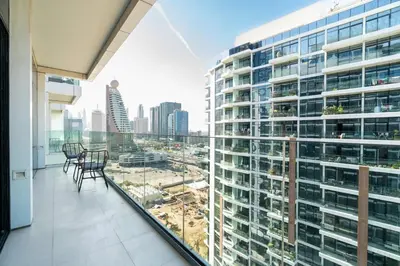 a balcony with chairs and a view of a city at CitiHome - Spacious 2BR - Park Gate Residences in Dubai