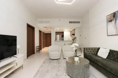a living room with a couch and a tv at CitiHome - Spacious 1BR - Park Gate Residences in Dubai