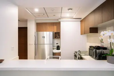 a kitchen with a stainless steel refrigerator at CitiHome - Spacious 1BR - Park Gate Residences in Dubai