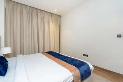 a bedroom with a white bed and a window at CitiHome - Iconic 1BR Jumeirah Living Marina Gate in Dubai