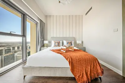 a bedroom with a large bed and a large window at VayK -Downtown Dubai Chic 1BR Retreat in Dubai
