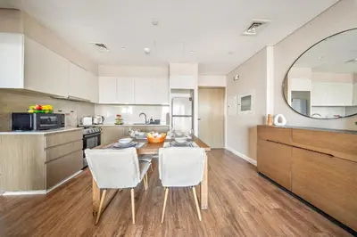 a kitchen with a table and chairs in a room at VayK -Downtown Dubai Chic 1BR Retreat in Dubai