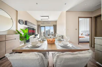 a kitchen and living room with a table and chairs at VayK -Downtown Dubai Chic 1BR Retreat in Dubai