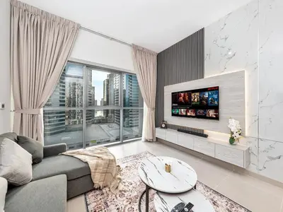 a living room with a couch and a tv at Elegant 1BR in Bellevue Towers Downtown Dubai in Dubai