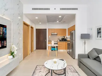 a living room with a couch and a table at Elegant 1BR in Bellevue Towers Downtown Dubai in Dubai