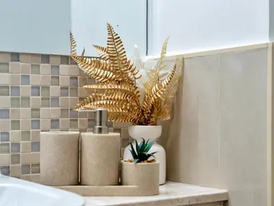 two potted plants sitting on a counter in a bathroom at Elegant 1BR in Bellevue Towers Downtown Dubai in Dubai