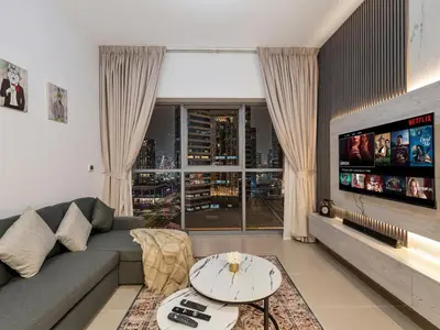 a living room with a couch and a tv at Elegant 1BR in Bellevue Towers Downtown Dubai in Dubai