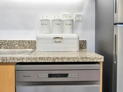 a kitchen with a counter with three containers on it at Elegant 1BR in Bellevue Towers Downtown Dubai in Dubai