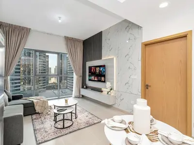 a living room with a couch and a fireplace at Elegant 1BR in Bellevue Towers Downtown Dubai in Dubai