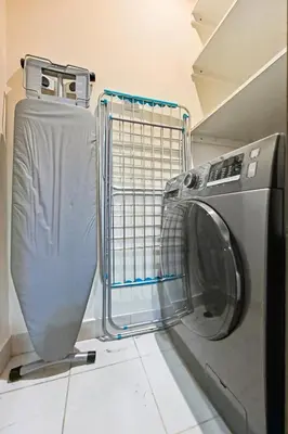 a washing machine and a washer in a room at Luxury Apt in Lofts Downtown, Walk to Dubai Mall, Burj Khalifa, Gym, Pool, 500mbps Wifi in Dubai