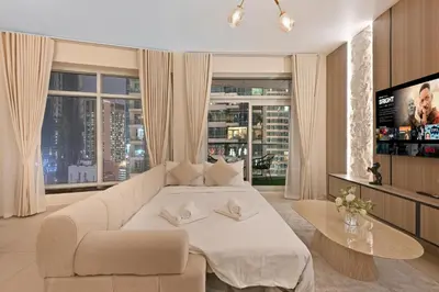 a living room with a couch and a table at Luxury Apt in Lofts Downtown, Walk to Dubai Mall, Burj Khalifa, Gym, Pool, 500mbps Wifi in Dubai