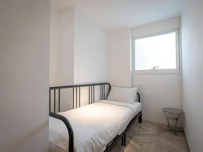 a small bedroom with a bed and a window at Daniels Spacious 3BR with Maid at Five Palm Jumeirah in Dubai