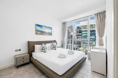 a bedroom with a bed and a large window at Stylish Apartment Business Bay Prime Location in Dubai