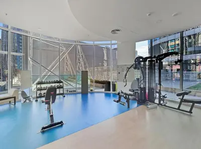 a gym with treadmills and exercise equipment in a building at Stylish Apartment Business Bay Prime Location in Dubai