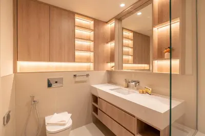 a bathroom with a sink and a toilet and a mirror at PVH - Chic Pool View 2BR Near Dubai Hills Park - Park Field Tower 2 in Dubai