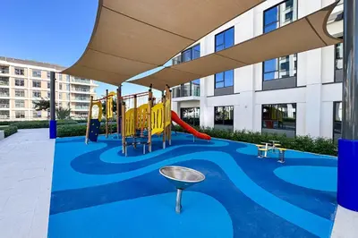 a playground in a building with a slide at PVH - Chic Pool View 2BR Near Dubai Hills Park - Park Field Tower 2 in Dubai