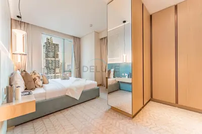 a bedroom with a large bed and a bathroom at Direct Walking Access to Dubai Mall and Burj Khalifa with Metro Connectivity to Prime Attractions - Vida Dubai Mall Tower 2, Downtown Dubai by Deluxe Holiday Homes in Dubai