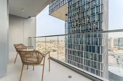 a balcony with a chair and a large window at Direct Walking Access to Dubai Mall and Burj Khalifa with Metro Connectivity to Prime Attractions - Vida Dubai Mall Tower 2, Downtown Dubai by Deluxe Holiday Homes in Dubai