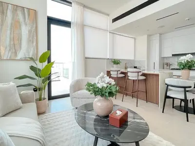 a living room with a vase of flowers on a glass table at Dubai Premium 2BR with Private Pool and Balcony! in Dubai