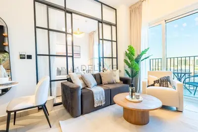 a living room with a couch and a table at Steps from Dubai Hills Mall, Near Scenic Park, and Easily Connected to Dubai Top Attractions - Socio Tower 1, Dubai Hills by Deluxe Holiday Homes in Dubai