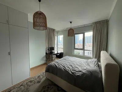 a bedroom with a bed and a large window at Urban Core - Downtown Dubai in Dubai