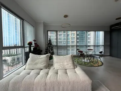 a bedroom with a white bed and a christmas tree at Urban Core - Downtown Dubai in Dubai