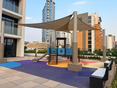 a playground with a slide and a canopy at Modern 2BR with Balcony in Azizi Riviera 23 in Dubai